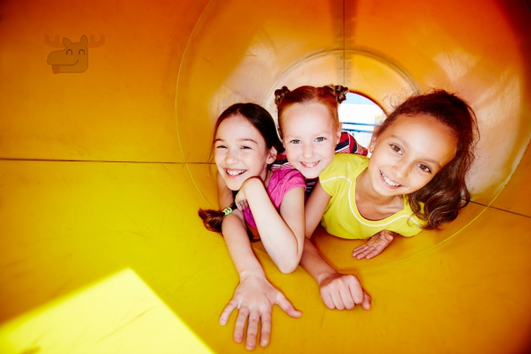 Image of happy little girls looking at camera while enjoying leisure