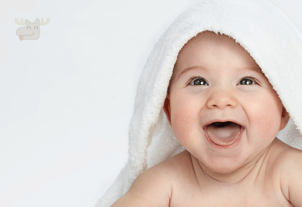 little child baby smiling lying under thr towel