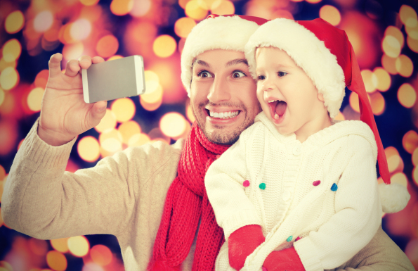 Selfe  In Christmas. Happy Family Dad Playing With Daughter And Photographed On  Mobile Phone